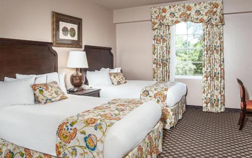 a hotel room with two beds and a window at Menger Hotel in San Antonio