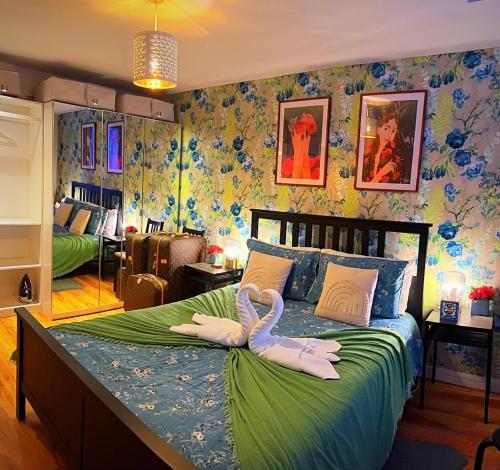 two swans sitting on a bed in a bedroom at Latitude Chinatown Central Apartment in Birmingham