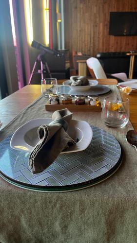 a table with two plates and a napkin on it at The Dome House in Bowness-on-Windermere