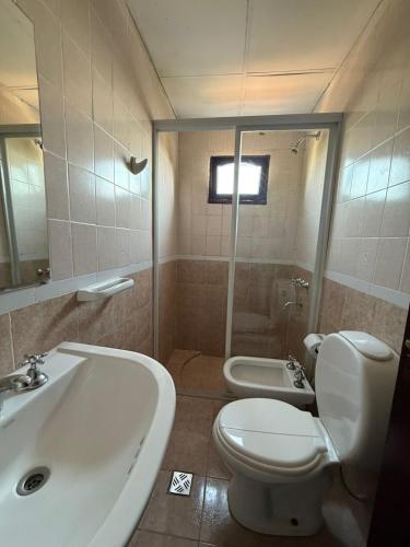 a bathroom with a white toilet and a sink at HOTEL REGINA Formosa in Formosa