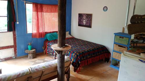 une petite pièce avec un lit et une fenêtre dans l'établissement Kailash, à La Porteña