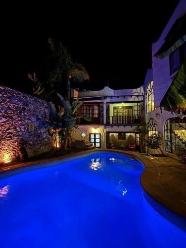 a large blue swimming pool in front of a house at Hotel Casa Loreto San Miguel de Allende in San Miguel de Allende