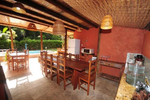 a kitchen and dining room with a table and chairs at Mandacaru Pousada in Porto Seguro