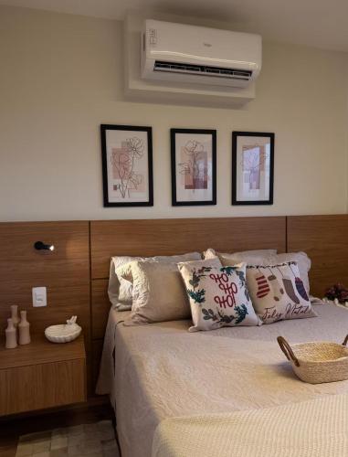 a bedroom with a bed with pillows and a fan at Flat 1807 - Sunset Experience Alto Padrão in Dourados