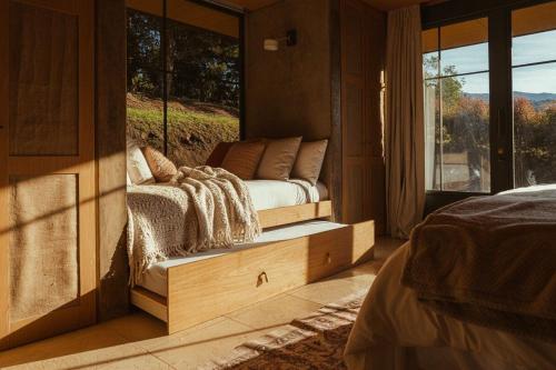 a bedroom with a bed and a large window at Summit Escape Peace & Comfort in Cartago