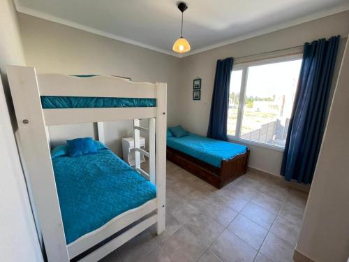 Postel nebo postele na pokoji v ubytování Complejo LA OMA, ubicado a 400 mts del mar con estacionamiento privado