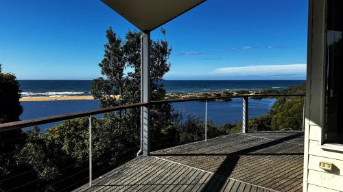 a view of the ocean from the balcony of a house at Pelicans Perch - Scenic Coastal Retreat in Lake Tyers