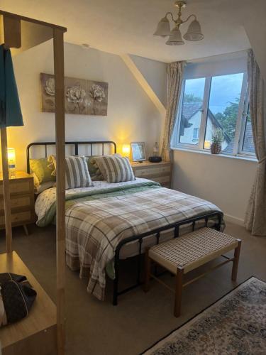 a bedroom with a bed and a window at Grayrigge Croft Cottage in Grange Over Sands
