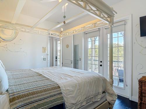 a bedroom with a large bed and a window at Inn on the Avenue in New Smyrna Beach