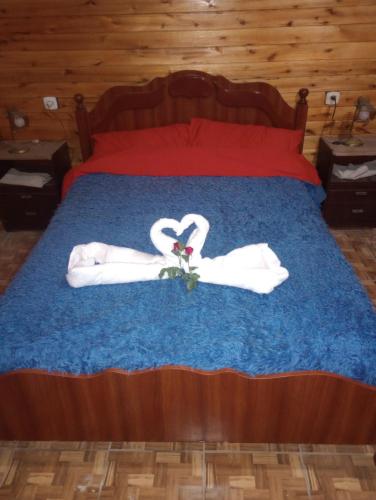 un lit avec des serviettes blanches et une paire de chaussures dans l'établissement Cabaña el amanecer, à Dolores