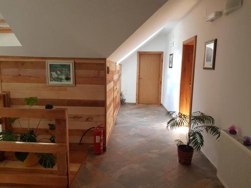a hallway with wooden walls and a potted plant at Villa Stone in Rakovica