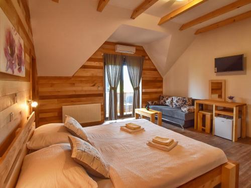 a bedroom with a bed and a living room at Villa Stone in Rakovica