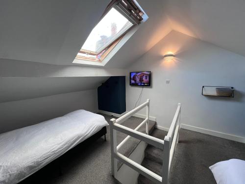 a bedroom with a bunk bed and a window at The Bluebird Rooms II in Headingley