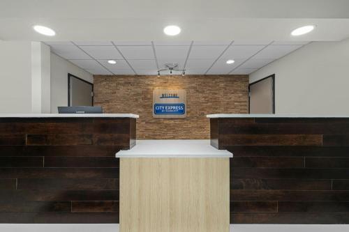 a lobby with a sign on a brick wall at City Express by Marriott Yulee in Yulee