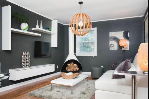 a living room with a couch and a fireplace at Village District Condo in Raleigh