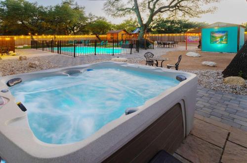 a large hot tub in a yard with a playground at Jungle Haven Heated Pool Fun for 12 in Johnson City
