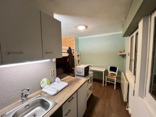 a kitchen with a sink and a counter top at Studio centre-ville in Cluses