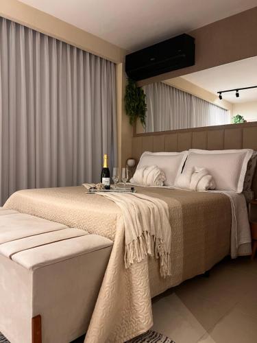 a bedroom with a bed with a bottle of champagne at Studio na Árvore no Centro do Rio in Rio de Janeiro