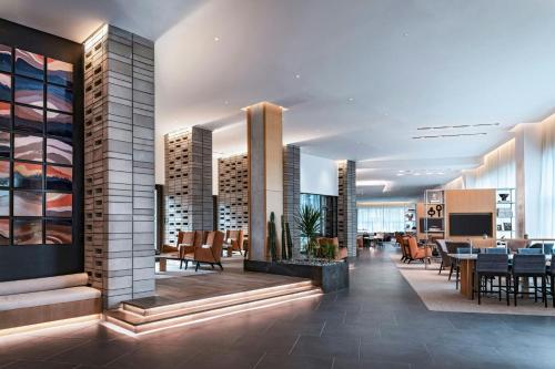 a lobby of a hotel with tables and chairs at AC Hotel by Marriott Phoenix North Norterra in Phoenix