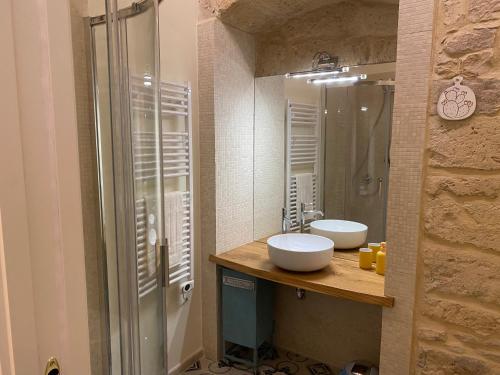 a bathroom with two sinks and a shower at DaDa' Home in Trani