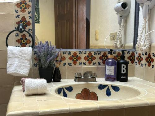 a bathroom counter with a sink and a mirror at Hotel Casa Loreto San Miguel de Allende in San Miguel de Allende