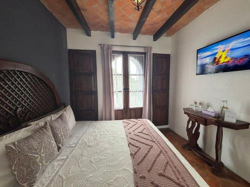 a bedroom with a large bed and a window at Hotel Casa Loreto San Miguel de Allende in San Miguel de Allende