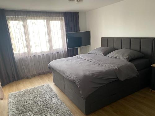 a bedroom with a bed and a flat screen tv at New komplett möblierte Wohnung-Zentral in Sindelfingen