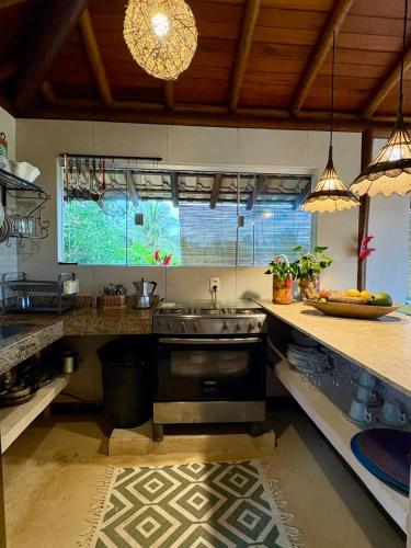 a kitchen with a sink and a counter at Vila BeiradeiRô - Taipu de Fora in Taipu