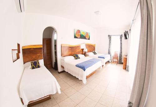 a bedroom with two beds in a room at Hotel Dos Mundos Monterrico - Pacific Resort in Taxisco