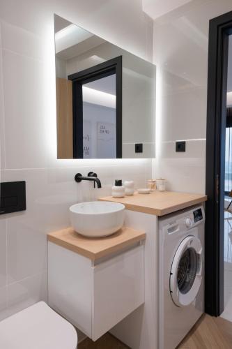 a bathroom with a sink and a washing machine at You and the view in Mytilene