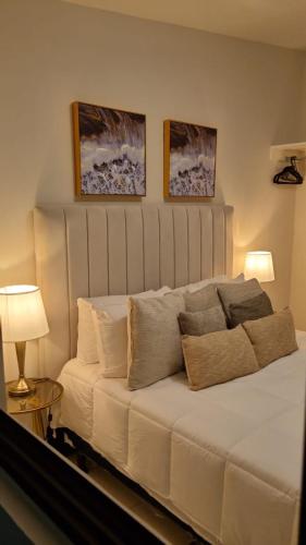a white couch in a room with two pictures on the wall at Cozy House! San Miguel in San Miguel