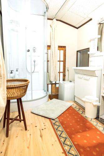 a bathroom with a tub and a sink at 隠れ古宿 おくゆかし in Beppu