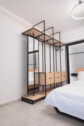 a bedroom with a bed and a black book shelf at You and the view in Mytilene