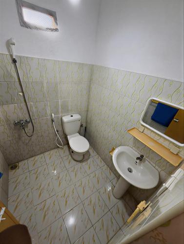 a bathroom with a toilet and a sink at Athula Beach Front Hotel Hikkaduwa in Hikkaduwa