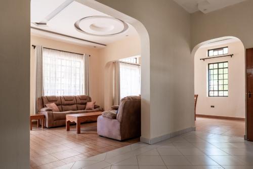 a living room with a couch and a chair at Ngelenyi Homes in Voi