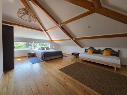 a bedroom with a bed and a couch in a room at Casa Lage da Pena in Geres