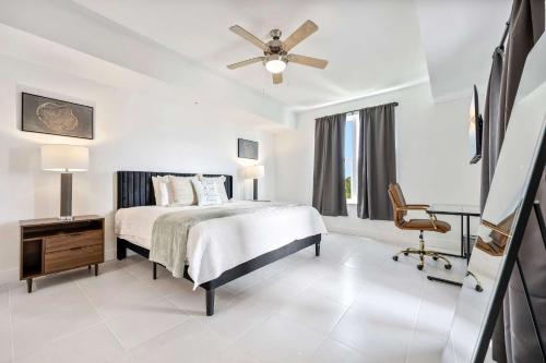 a white bedroom with a bed and a ceiling fan at RIVER FLY IN The Cocoa Island Horizon View RFI 3BR KQQ City in Audubon
