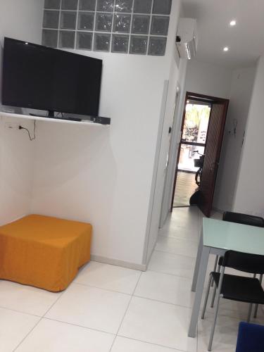a living room with a flat screen tv on a wall at Appartamento Regonini in Alassio