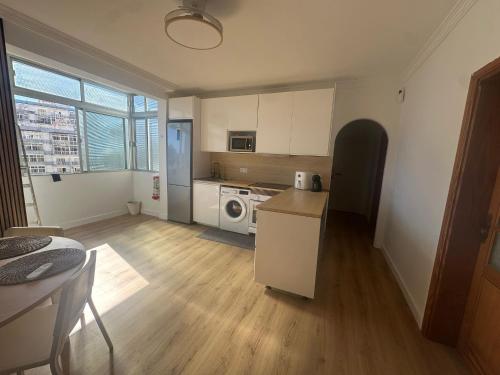 a kitchen with a refrigerator and a stove top oven at Room Mayi GC in Las Palmas de Gran Canaria
