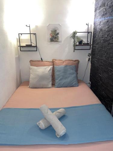 a bed with two pairs of socks on it at Le Cocon de la Bastille - DaLoc in Grenoble