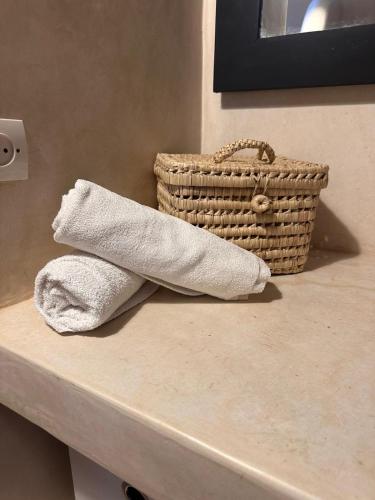 a towel sitting on a counter with a basket at Villa Léa in Marrakesh