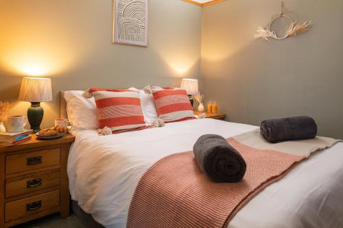 a bedroom with a bed with two pillows on it at Heligog at Deanfield House Moelfre Sea view adult only appartment in Moelfre in Moelfre