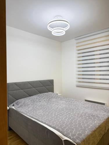 a bedroom with a bed in a white room at Prestige Forest Resort Zlatibor Wellness & Spa in Zlatibor