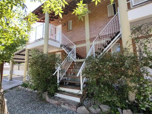 a building with stairs and trees in front of it at Lo de Vlady in Mina Clavero