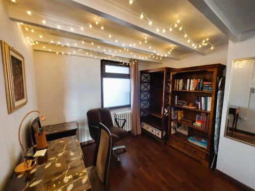 Una sala de estar con una mesa, sillas y luces. en Casa nonna Gina, en San Francesco al Campo