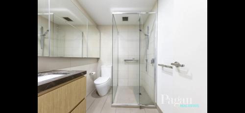 a bathroom with a toilet and a glass shower at Ascot Hill in Melbourne