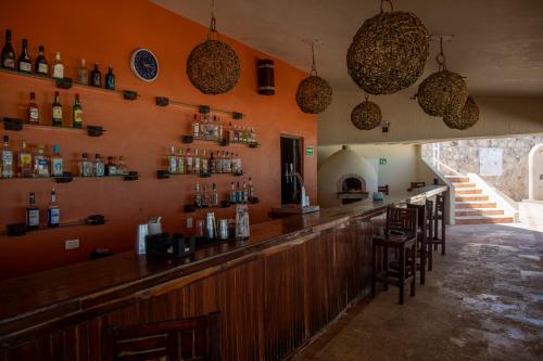 a bar with a bunch of bottles on the wall at BeachAccess HotelZone 3705 in Cancún