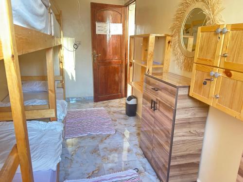a bedroom with bunk beds and a mirror at Talia Surf Morocco in Taghazout