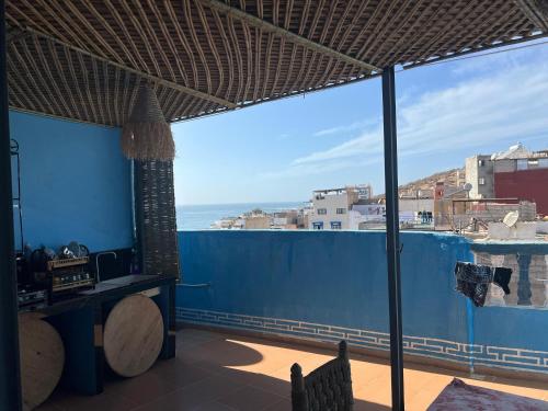 a room with a view of the ocean from a balcony at Talia Surf Morocco in Taghazout
