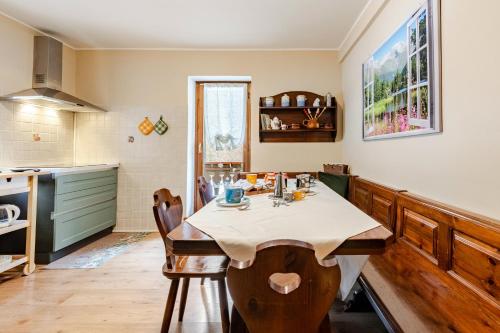 a kitchen with a table in a room at Casa Ai tre cavalli vista sulle Dolomiti in Val di Zoldo